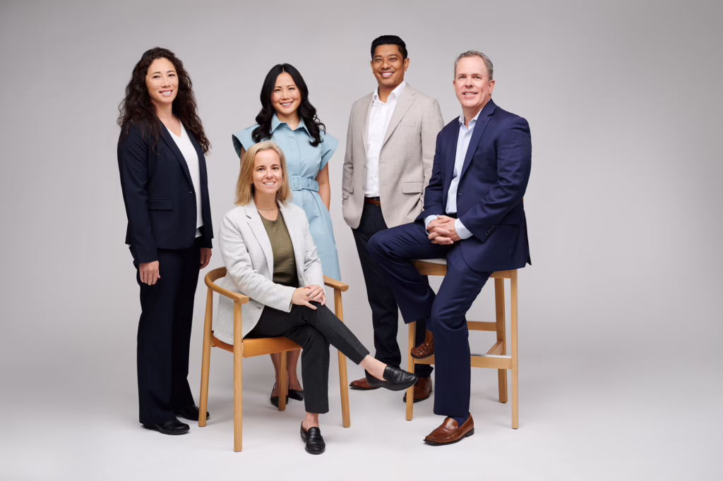 Three women and two men in business attire gathered together: This is the Board of Managers of Veris: Nicole Davis, Lori Choi, Roraj Pradhananga, Brad Mook (Rosemont Investment Group) and Sheryl Kucer.