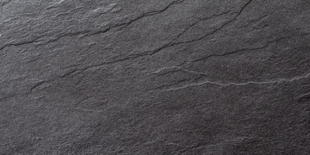 Fine-grained dark stone surface, evenly textured and unmarked.