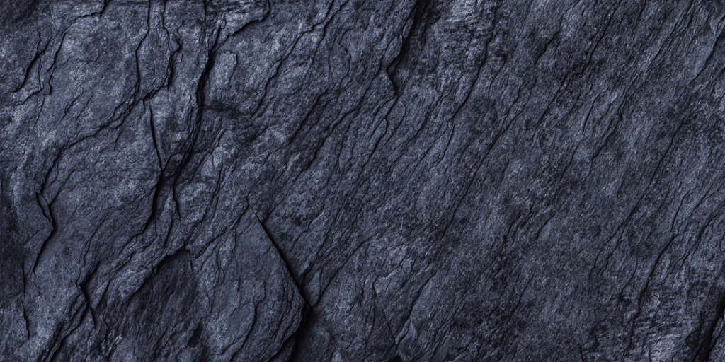 Black stone surface with a horizontal grain running across the frame.